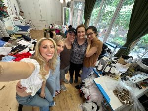 Ava and her trainer with the women who made her new dress.
